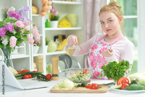 teen girl preparing fresh salad