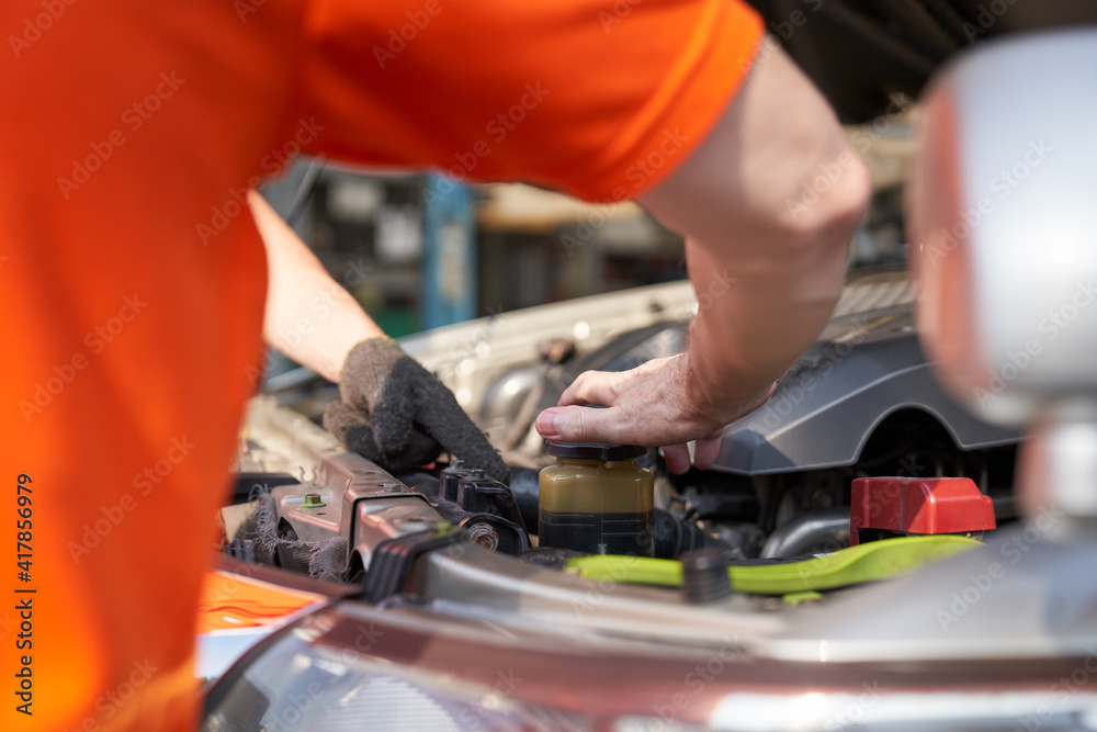 Mechanic try to open radiator car for refilling water to maintainance time Mechanic try to open radiator car for refilling water to maintainance time
