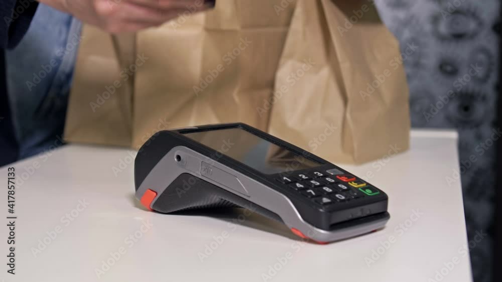 Buyer pays for the coffee using the phone. Contactless payments. Buyer pays for the coffee using the phone. Contactless payments.