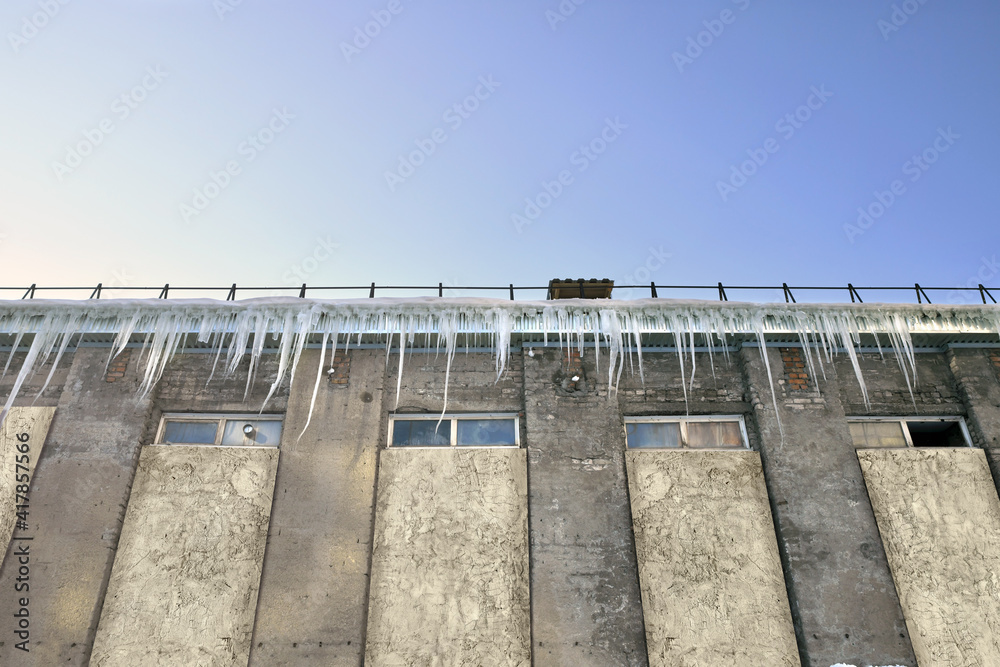 An emergency building with dangerously hanging ice icicles.