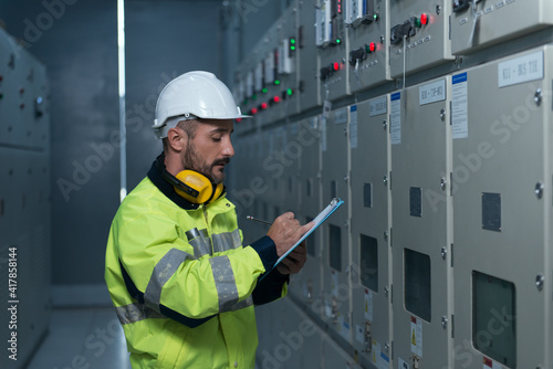 engineer working on the checking status switchgear electrical energy distribution substation photo