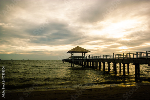 wood bridge in evening at Casaluna village in Thailand , wooden pier on the beach ,Wooded bridge in the port between sunrise.