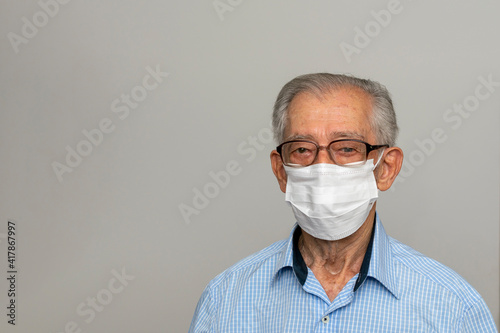 Elderly Brazilian man wearing face mask during a Covid-19 pandemic. Space for text