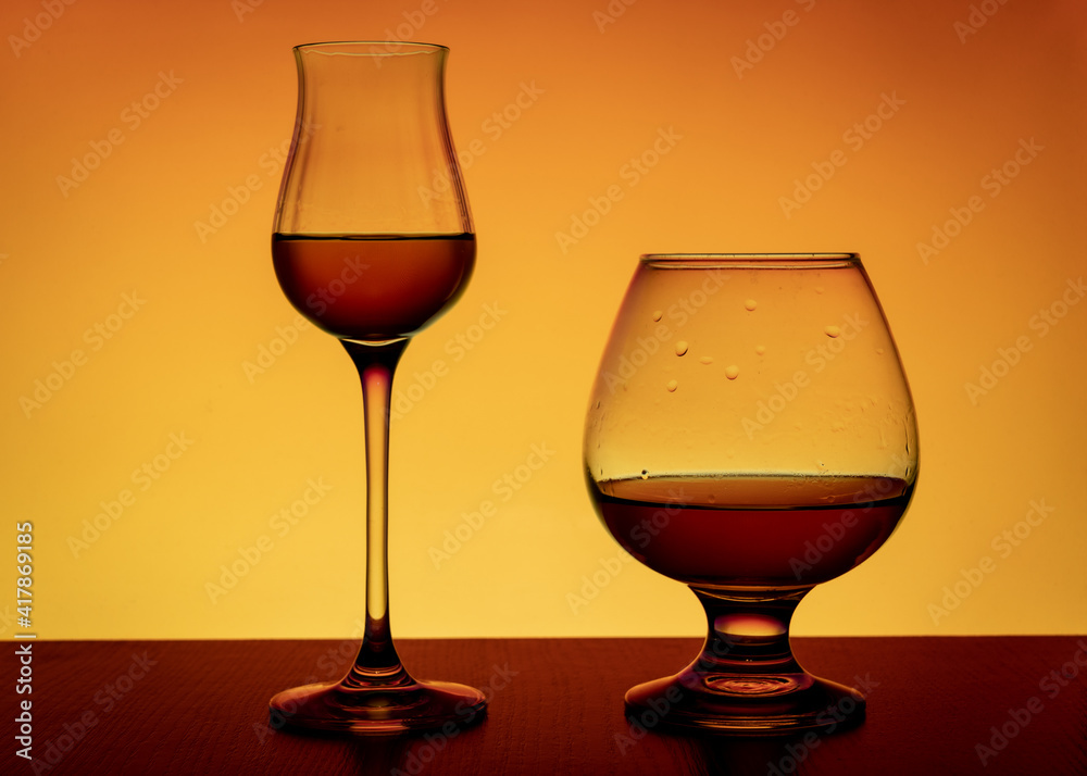 Tulip and snifter glass on an orange background