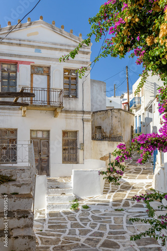 Picturesque alley in lefkes Paros greek island with a full blooming bougainvillea !! Whitewashed traditional houses and flowers all over !!!