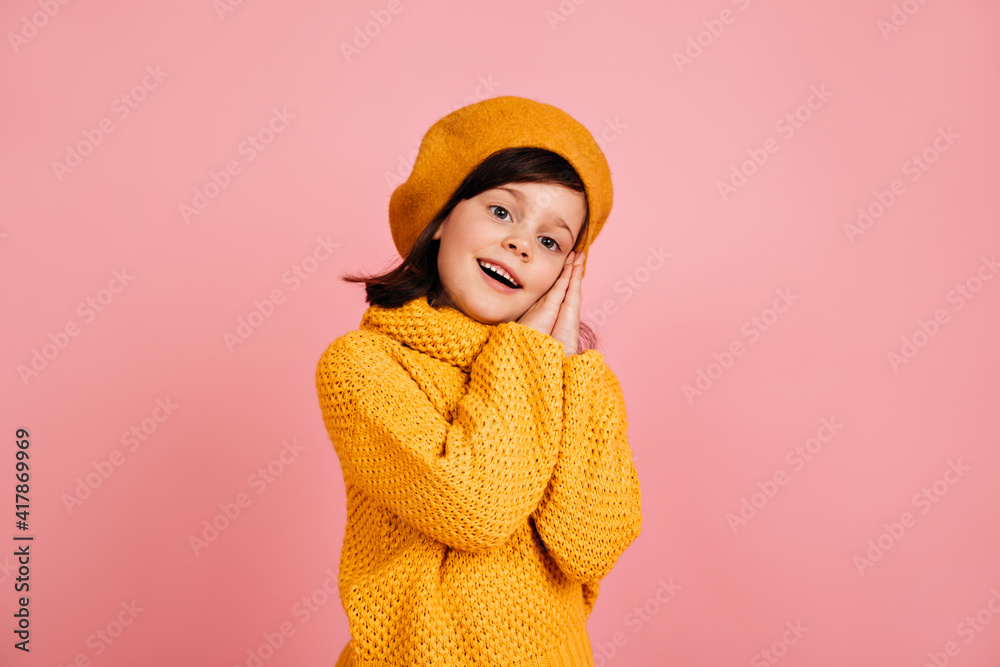 Inspired child posing on pink background. Studio shot of short-haired preteen girl. Inspired child posing on pink background. Studio shot of short-haired preteen girl.