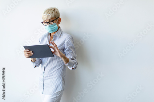 Mature businesswoman using ...
