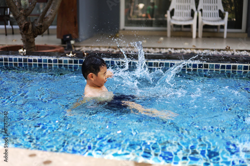 Asia children relaxation and playing in the water In the hotel pool during the holidays.