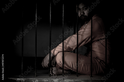 Asian man desperate at the iron prison,prisoner concept,thailand people,Hope to be free,Serious prisoners imprisoned in the prison