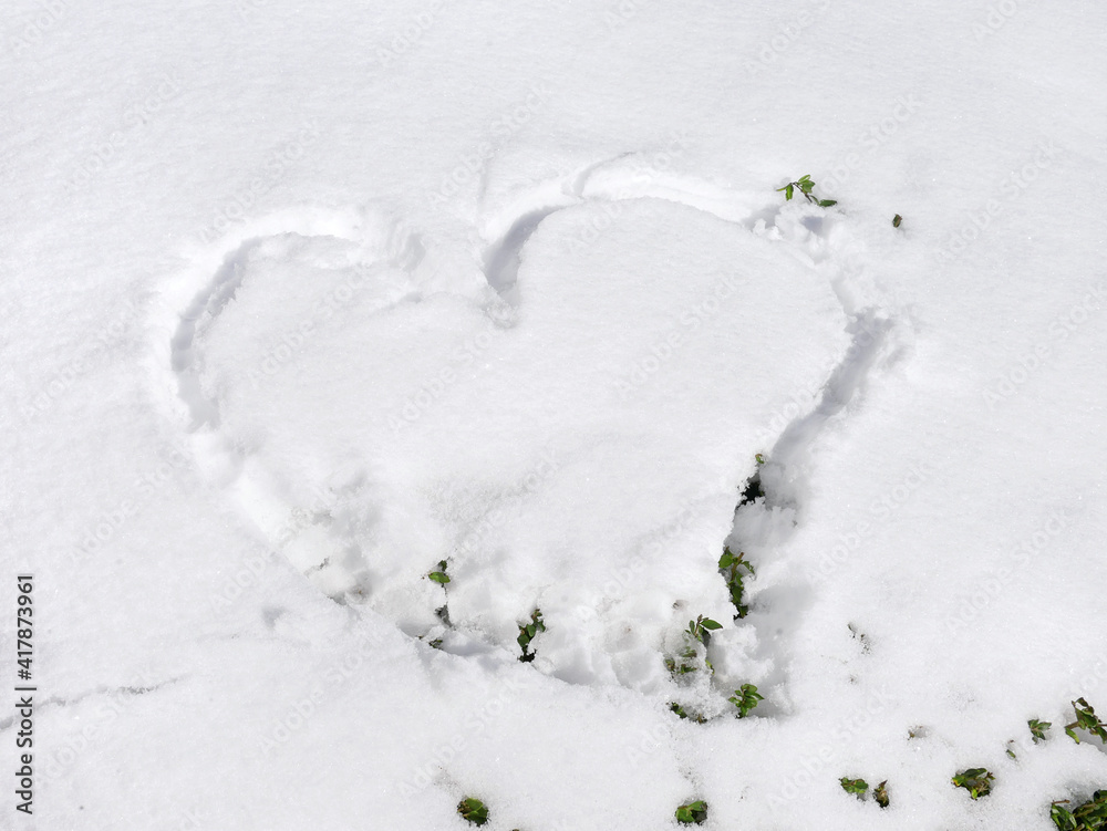 Heart shape drawn on the fresh snow. Winter nature background Heart shape drawn on the fresh snow. Winter nature background