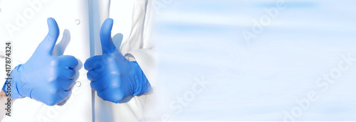 thumb up of doctor or nurse in protective medical gloves on white laboratory kittel background. medical research and protection banner with copy space