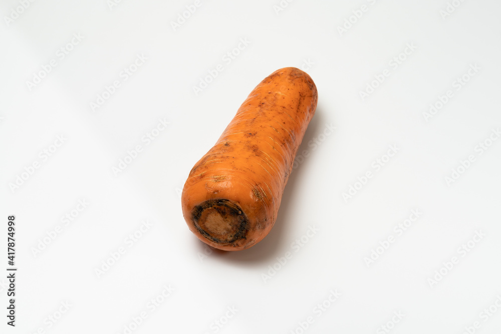 a Dirt-stained carrot isolated on white background