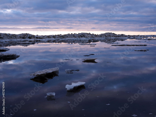 Spring coast of the Arctic Ocean. Beautiful sky and ice crystals. Artistic noise