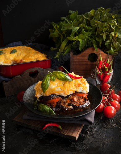 Traditional Greek moussaka on a dark background. Selective focus.