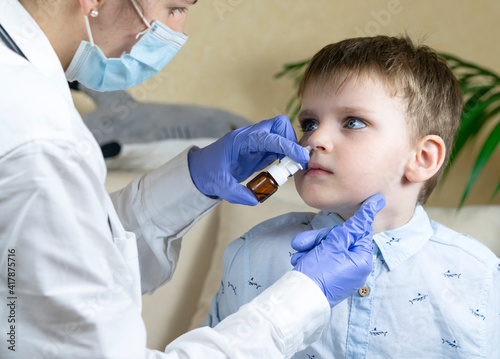 Prevention of rhinitis. Doctor instills medicine into the child s nose