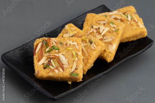 Indian Mithai Lachedar Patisa With Various Names Soan Papdi San Papdi Sohan Papdi Sukhdi Or Sonpapdi Son Roll Is Made Of Gram Wheat Flour Besan Kaju Pista Badam Dry Fruits Jaggery Fried In Desi Ghee photo