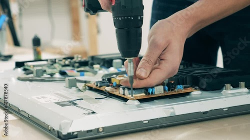 Wallpaper Mural Electronic device is getting dismantled by a repairman Torontodigital.ca