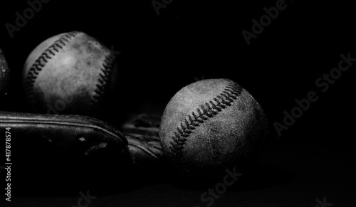 Nostalgia feel of baseball sports equipment in black and white with old used balls.