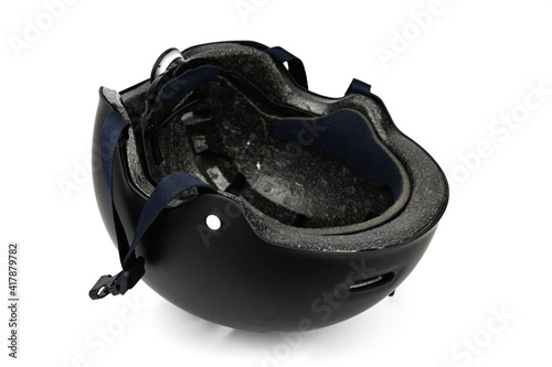 Black cycling helmet lying upside down.
