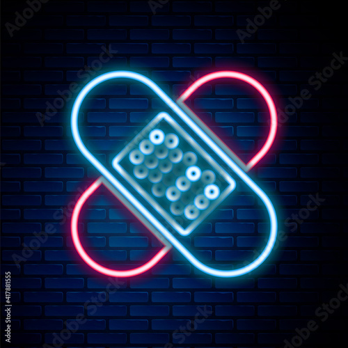 Glowing neon line Crossed bandage plaster icon isolated on brick wall background. Medical plaster, adhesive bandage, flexible fabric bandage. Colorful outline concept. Vector.