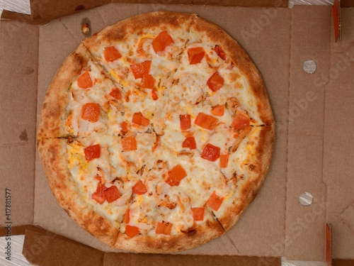 Pizza in an open cardboard box, top view