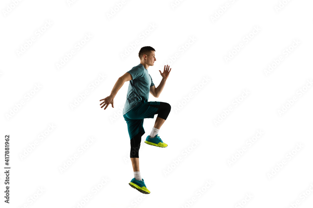 Jumping. Young caucasian male model in action, motion isolated on white background with copyspace. Concept of sport, movement, energy and dynamic, healthy lifestyle. Training, practicing. Authentic.