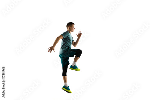 Jumping. Young caucasian male model in action, motion isolated on white background with copyspace. Concept of sport, movement, energy and dynamic, healthy lifestyle. Training, practicing. Authentic.