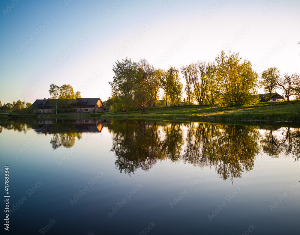 Beautiful Tree Reflection in Lake on Sunny Day - Autumn Colors Beautiful Tree Reflection in Lake on Sunny Day - Autumn Colors