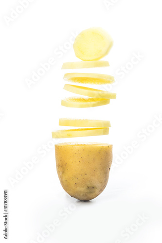 Potato slices turning into chips isolated on white background