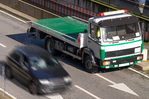 towing truck car wrecker working in city street