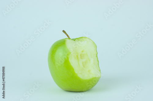 Green Apple with a white background with big bite taken