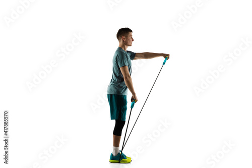 Work out. Young caucasian male model in action, motion isolated on white background with copyspace. Concept of sport, movement, energy and dynamic, healthy lifestyle. Training, practicing. Authentic. © master1305