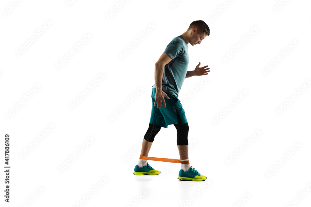 Work out. Young caucasian male model in action, motion isolated on white background with copyspace. Concept of sport, movement, energy and dynamic, healthy lifestyle. Training, practicing. Authentic. Work out. Young caucasian male model in action, motion isolated on white background with copyspace. Concept of sport, movement, energy and dynamic, healthy lifestyle. Training, practicing. Authentic.