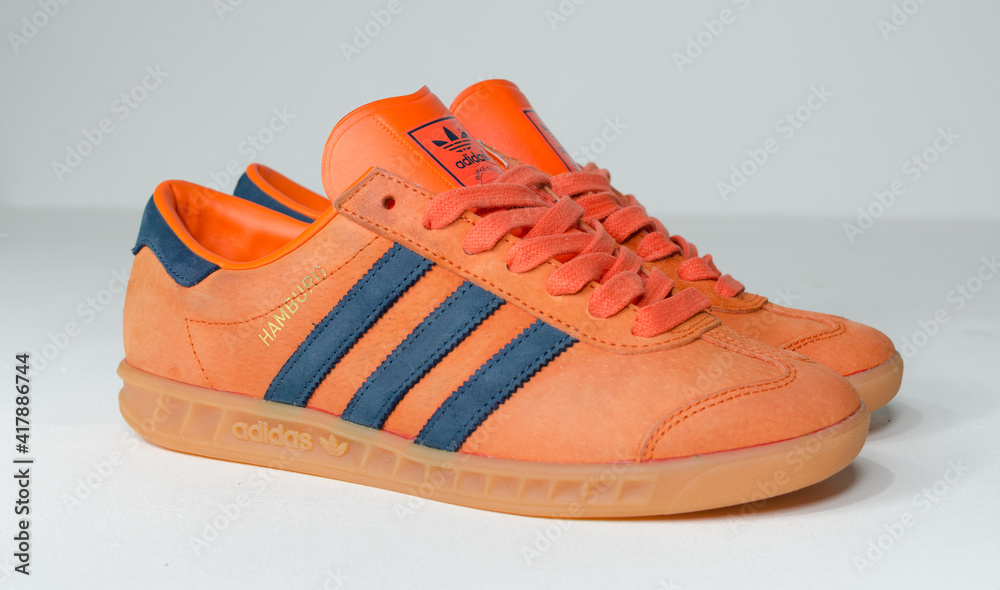london, uk 05.03.2021 Adidas Hamburg sneaker, Super and Sub Blue with Gum sole. Trainers vintage sneaker trainers. orange suede adidas trainers, stylish fashion. Stock Photo | Adobe Stock
