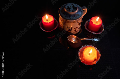 Chinese tea served in a nice teapot around candles