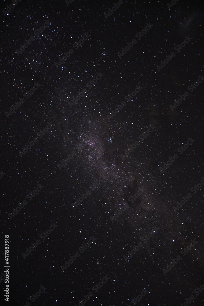 a long exposure of the dark sky with the stars