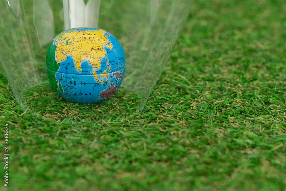 Naklejka premium A globe on the lush green grass. Earth Day.