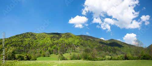 beautiful bavarian landscape in spring, Rottach valley with view to green hill. blue sky with clouds photo