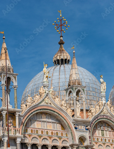 Decoration elements at roofs and cupolas of Basilica San Marco in Venice, Italy, at sunny day and deep blue sky