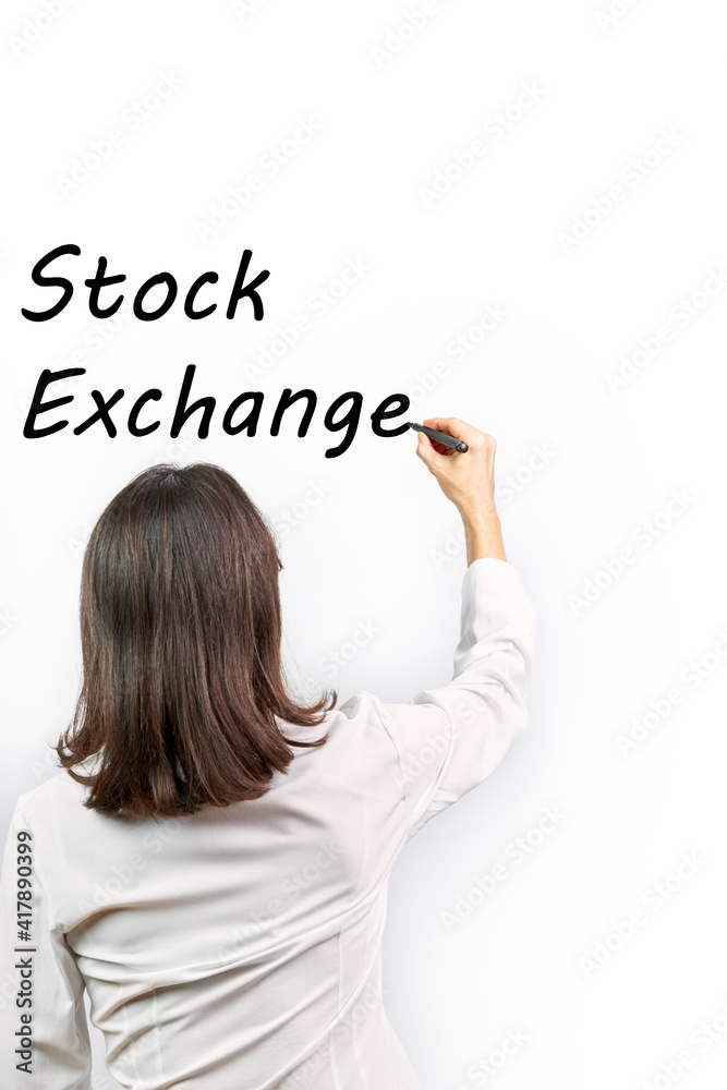 Business woman writing the word stock exchange on a white background Business woman writing the word stock exchange on a white background