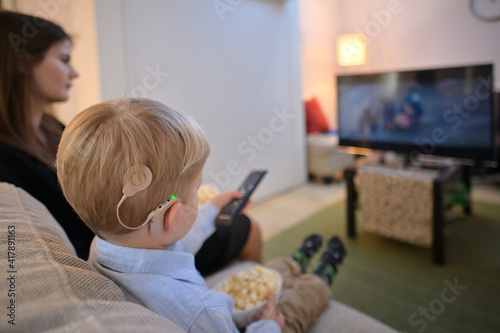 A Boy With Cochlear Implants watching Television