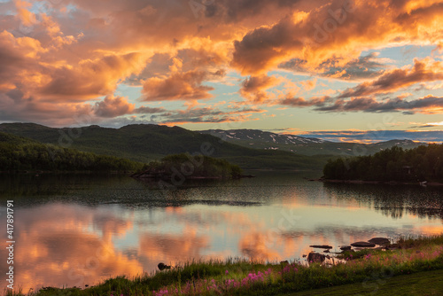 reflections at dawn on the lake of Vuoggatjalme  sweden