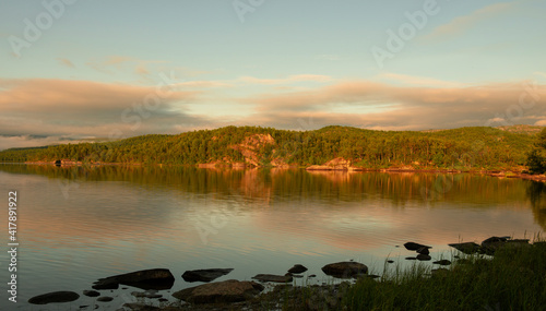 reflections at dawn on the lake of Vuoggatjalme, sweden photo