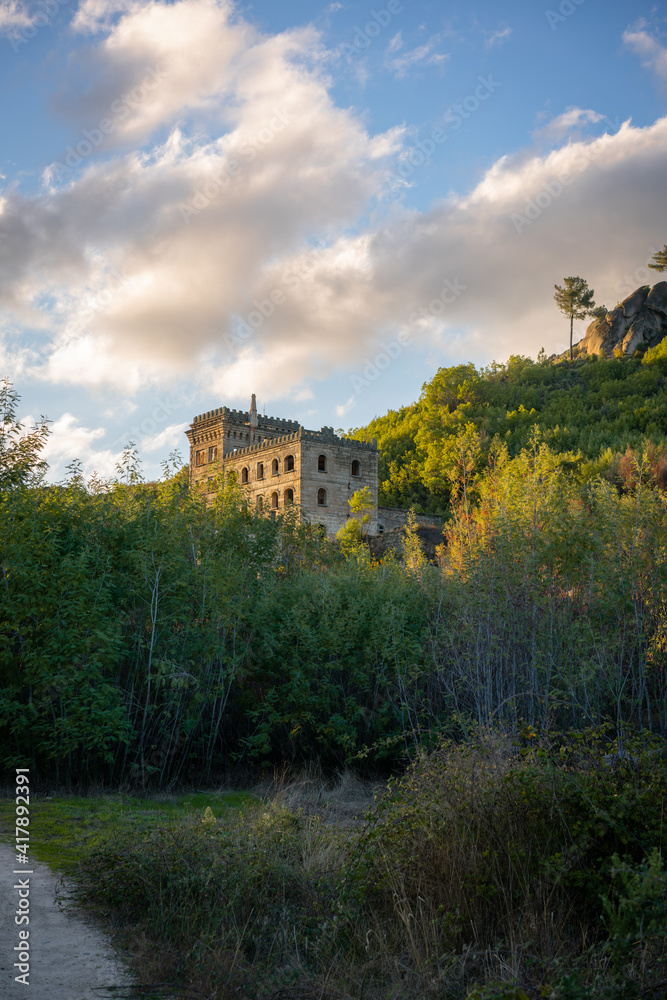 Abandoned ruin building of Termas Radium Hotel Serra da Pena in Sortelha with beautoful colorful trees at sunset, Portugal