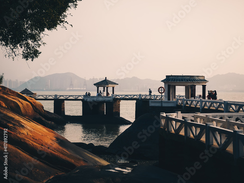 Landscape of Gangzihou beach with ancient stone bridge,located in Gulangyu island,Xiamen,Fujian,China photo