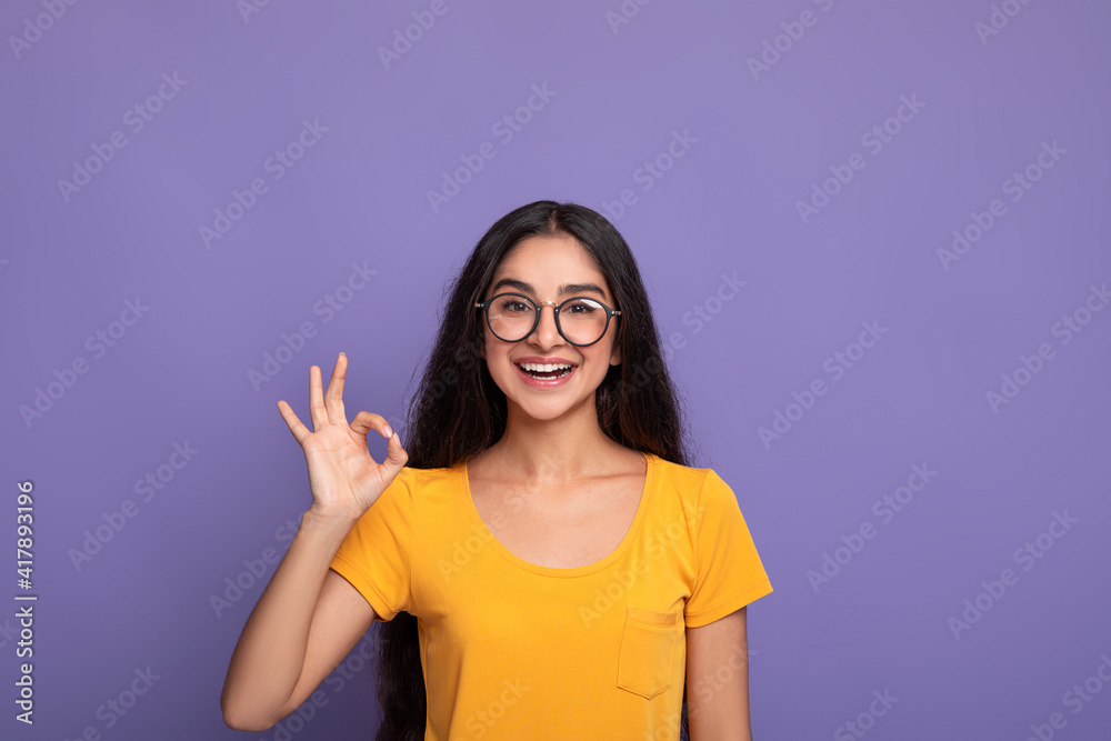 Happy insian woman gesturing ok sign and smiling