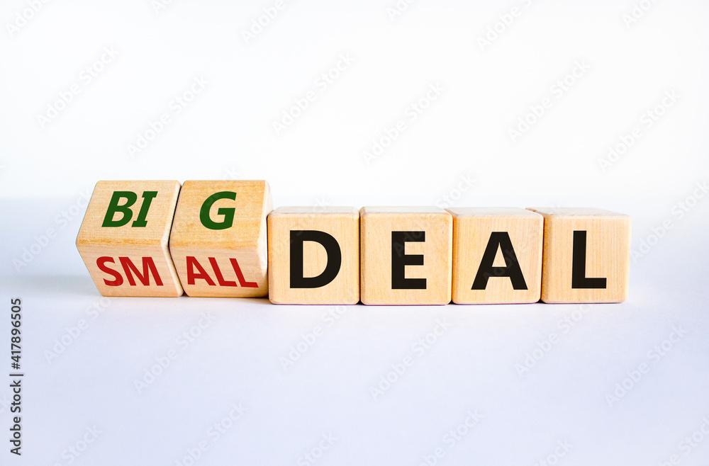 Big or small deal symbol. Turned wooden cubes and changed words 'small deal' to 'big deal'. Beautiful white table, white background, copy space. Business and big or small deal concept. Big or small deal symbol. Turned wooden cubes and changed words 'small deal' to 'big deal'. Beautiful white table, white background, copy space. Business and big or small deal concept.