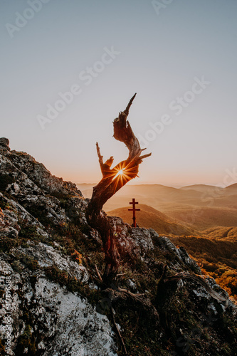 Silhouettes with bright sunset on the colorful sky background in mountains