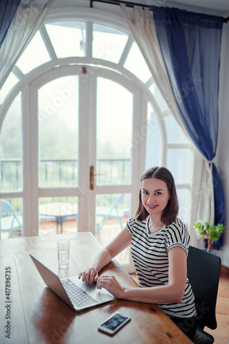 Working at home. Freelance concept. Pretty young woman using laptop at her apartment. Free Download Working at home. Freelance concept. Pretty young woman using laptop at her apartment. - GFXLoad