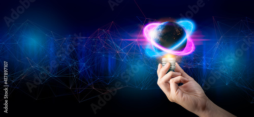 Fototapeta Naklejka Na Ścianę i Meble -  Concept of creative thinking ideas and innovation.Hand holding earth bulb and growth light on network connection background.Earth day and Energy saving concept.Elements of this image furnished by NASA
